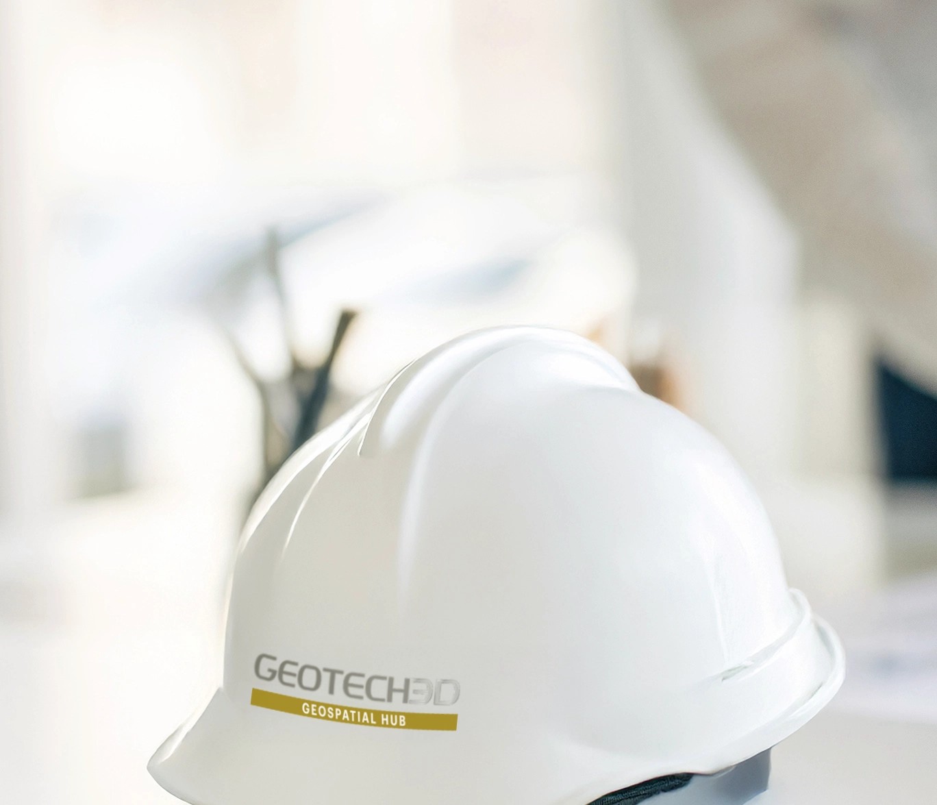 GEOTECH 3D safety helmet beside engineering project drawings
